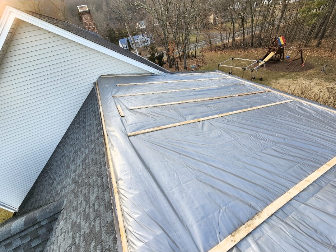 Emergency roof tarping after wind damage